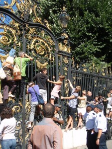 Bastille Parade - people climb down gate Bastille Parade - people climb down gate