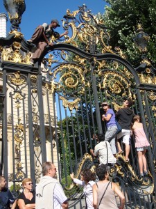 Bastille Parade - people climb on gate