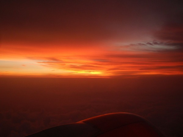 Sunset from the sky above the clouds, during Bali Java flight, Indonesia