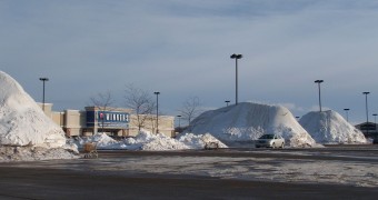Snow pile at shopping center's parking lot in our hometown in Canada