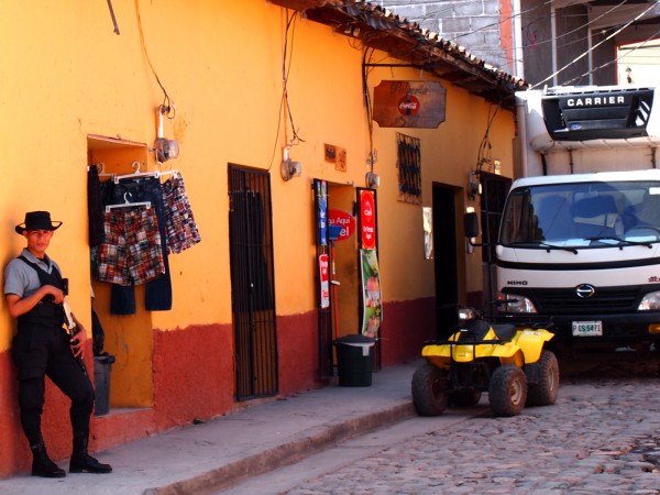 Armed security guard in front of a clothing store in Copan Ruinas, Honduras