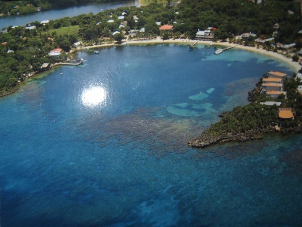 A postcard showing aerial shot of Half Moon Bay, Roatan Island, Honduras