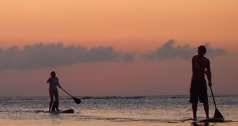 Paddleboarding 101: How to Paddleboard from Honduras to Belize Sunset paddleboarding in Roatan, Honduras