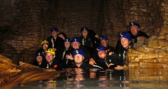 Black water rafting in underground river of the Waitomo glowworm cave, New Zealand