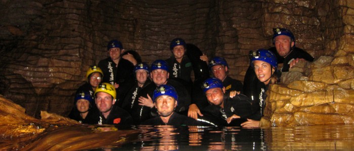 Black water rafting in underground river of the Waitomo glowworm cave, New Zealand